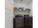 Laundry room equipped with a new washer and dryer and storage shelving at 13 Deseo Ct, North Las Vegas, NV 89031