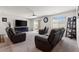 Cozy living room featuring a ceiling fan and natural light at 13 Deseo Ct, North Las Vegas, NV 89031