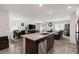 Open-concept kitchen and living area with modern appliances and dining space at 13 Deseo Ct, North Las Vegas, NV 89031