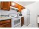 Charming kitchen featuring white appliances, modern counters, and wood cabinetry at 1361 E University Ave # 106, Las Vegas, NV 89119