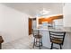 Bright kitchen with barstool seating, white counters and modern appliances at 1361 E University Ave # 106, Las Vegas, NV 89119