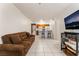 Open concept living room with kitchen, barstool seating and comfortable couch at 1361 E University Ave # 106, Las Vegas, NV 89119