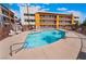 Outdoor pool and hot tub surrounded by apartments and patio furniture at 1361 E University Ave # 106, Las Vegas, NV 89119