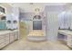 Lavish bathroom featuring dual sinks, a separate shower, tub, and vanity area at 1805 Prichard Ave, Henderson, NV 89052