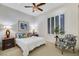 Comfortable bedroom featuring a ceiling fan, neutral walls, window with plantation shutters and art at 1805 Prichard Ave, Henderson, NV 89052