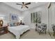 Cozy bedroom with a ceiling fan, white shutters, a comfortable bed, and stylish decor accents at 1805 Prichard Ave, Henderson, NV 89052