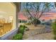 View of dining room and backyard with desert landscaping and decorative fountain at 1805 Prichard Ave, Henderson, NV 89052
