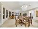 Spacious dining area featuring a chandelier, neutral walls, and multiple seating areas at 1805 Prichard Ave, Henderson, NV 89052