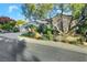 Charming single-story home featuring a three-car garage, tile roof, and lush, mature landscaping at 1805 Prichard Ave, Henderson, NV 89052