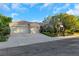 Charming single-story home featuring a three-car garage, tile roof, and lush, mature landscaping at 1805 Prichard Ave, Henderson, NV 89052