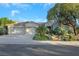 Charming single-story home featuring a three-car garage, tile roof, and lush, mature landscaping at 1805 Prichard Ave, Henderson, NV 89052