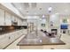 Open concept kitchen features granite counters, stainless steel appliances and island with hanging lights at 1805 Prichard Ave, Henderson, NV 89052