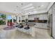 Bright eat-in kitchen with tile floors, gray cabinetry and an island with seating at 1805 Prichard Ave, Henderson, NV 89052