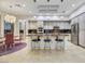 Eat-in kitchen features pendant lights, stone countertops, stainless appliances, and cream colored cabinets at 1805 Prichard Ave, Henderson, NV 89052