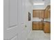 Functional laundry room with tile flooring, wooden cabinetry, and a sink, offering practicality at 1805 Prichard Ave, Henderson, NV 89052