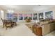Open concept living room and dining room with large windows providing lots of natural light at 1805 Prichard Ave, Henderson, NV 89052