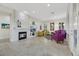 Bright living room with modern fireplace, colorful furnishings, and tile flooring at 1805 Prichard Ave, Henderson, NV 89052