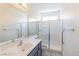Clean bathroom featuring a shower with glass doors, a large mirror, and a sleek vanity at 1904 Imola Ct, Las Vegas, NV 89123