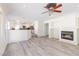 Open-concept living room featuring a fireplace and gray wood flooring at 1904 Imola Ct, Las Vegas, NV 89123