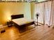 Comfortable bedroom featuring a queen bed with bedside table and lamp on wood laminate floors at 2080 Karen Ave # 34, Las Vegas, NV 89169