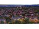 Expansive neighborhood view showcasing the Las Vegas skyline at twilight and many single Gathering homes at 2208 Point Rock Ln, Las Vegas, NV 89134
