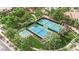 Aerial view of community tennis courts, basketball court, and lush landscaping at 2208 Point Rock Ln, Las Vegas, NV 89134