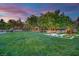 Expansive backyard with a large grassy area and mature trees, perfect for outdoor activities at 2208 Point Rock Ln, Las Vegas, NV 89134