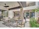 An impressive outdoor living space featuring stone columns, comfortable seating, and a view of the home's architecture at 2208 Point Rock Ln, Las Vegas, NV 89134
