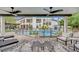 Inviting outdoor space with covered patio, complete with outdoor seating, a pool, and lush greenery at 2208 Point Rock Ln, Las Vegas, NV 89134