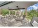 Relaxing outdoor patio with comfortable seating, a stone fireplace, and beautiful landscaping at 2208 Point Rock Ln, Las Vegas, NV 89134