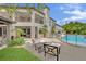 Expansive covered patio, outdoor furniture, a swimming pool with a slide, and well-manicured landscaping at 2208 Point Rock Ln, Las Vegas, NV 89134