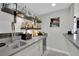 A bar area with a sink, floating shelves and a granite countertop at 2208 Point Rock Ln, Las Vegas, NV 89134