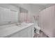 Bright bathroom with a modern marble-style vanity, sink, white cabinets, and a white toilet at 2208 Point Rock Ln, Las Vegas, NV 89134
