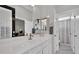 Bright bathroom featuring double doors to the main bedroom, dual sinks, and a walk-in shower at 2208 Point Rock Ln, Las Vegas, NV 89134
