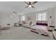Spacious bedroom with three beds, stylish decor, large windows with blinds, and plush carpeting at 2208 Point Rock Ln, Las Vegas, NV 89134