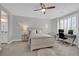 Bright bedroom featuring a bed, a desk area for working, and a large window with blinds at 2208 Point Rock Ln, Las Vegas, NV 89134