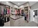 Custom closet featuring drawers, shelving and clothes racks, plus a central island with granite countertop at 2208 Point Rock Ln, Las Vegas, NV 89134