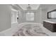 Elegant dining room with a tray ceiling, modern chandelier, and marble floors at 2208 Point Rock Ln, Las Vegas, NV 89134