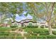 Beautiful two-story home featuring mature landscaping, a manicured lawn, and a circular driveway at 2208 Point Rock Ln, Las Vegas, NV 89134