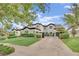 Well-maintained two-story home with a lush green lawn, mature shrubs, and a concrete driveway at 2208 Point Rock Ln, Las Vegas, NV 89134