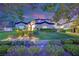Charming two-story home with lush landscaping and a welcoming front entrance at dusk at 2208 Point Rock Ln, Las Vegas, NV 89134