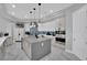 A modern, stylish kitchen with a large island, stainless steel appliances, and elegant pendant lighting at 2208 Point Rock Ln, Las Vegas, NV 89134