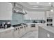 Bright kitchen featuring stainless steel appliances, white cabinets, and a stylish backsplash at 2208 Point Rock Ln, Las Vegas, NV 89134