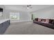 Spacious living room with gray carpet, a dark brown sofa, and a window view to the outdoors at 2208 Point Rock Ln, Las Vegas, NV 89134