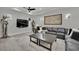 A stylish living room with a grey sectional, mounted TV, and unique decor at 2208 Point Rock Ln, Las Vegas, NV 89134