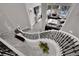 An open-concept living space viewed from above, showcasing an elegant curved staircase and bright, airy ambiance at 2208 Point Rock Ln, Las Vegas, NV 89134