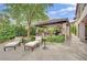 Entertainer's outdoor bar area with plenty of seating and lush backyard landscaping at 2208 Point Rock Ln, Las Vegas, NV 89134