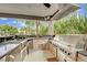 Outdoor kitchen with premium built-in stainless appliances at 2208 Point Rock Ln, Las Vegas, NV 89134