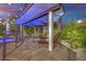 Covered outdoor space featuring lounge seating, a fireplace, and a view of the pool, perfect for entertaining at 2208 Point Rock Ln, Las Vegas, NV 89134