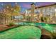 Lush backyard with sparkling pool, a raised hot tub, slide, and ample lounging space for ultimate relaxation at 2208 Point Rock Ln, Las Vegas, NV 89134